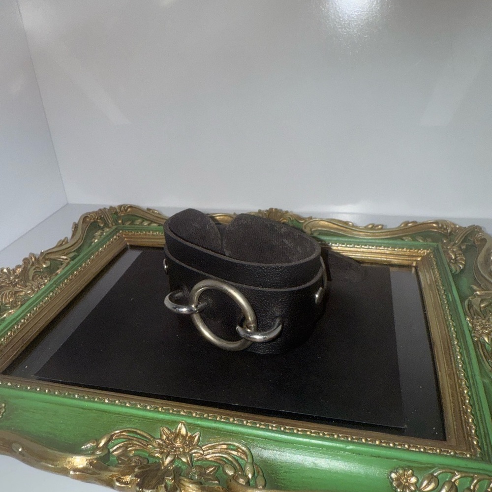 Black leather cuff with silver hardware